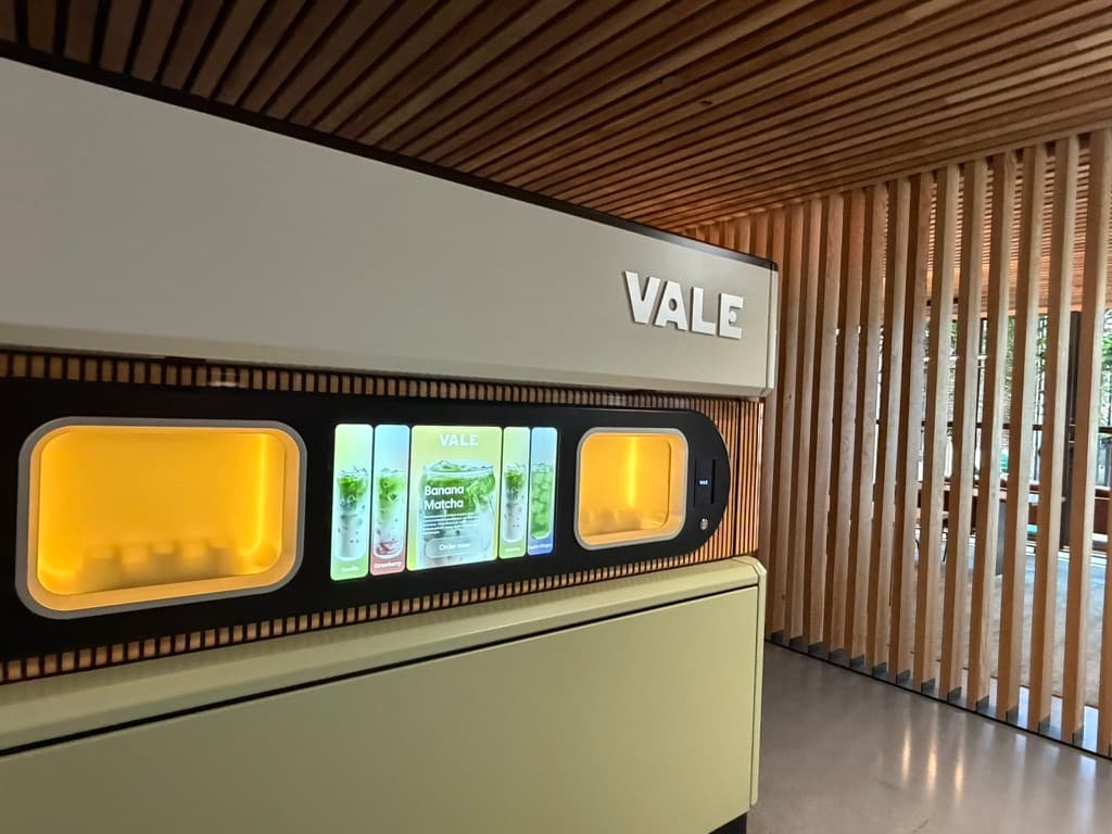 Close-up of the Vale self-service matcha bar touchscreen and dispensing windows at 505 First in Pioneer Square, Seattle