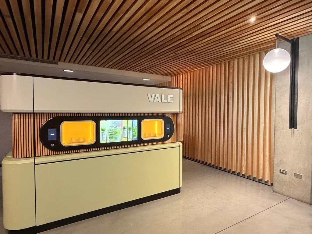 Vale self-service matcha bar in the lobby of 505 First in Pioneer Square, Seattle, with the VALE machine beneath a wood-slat ceiling