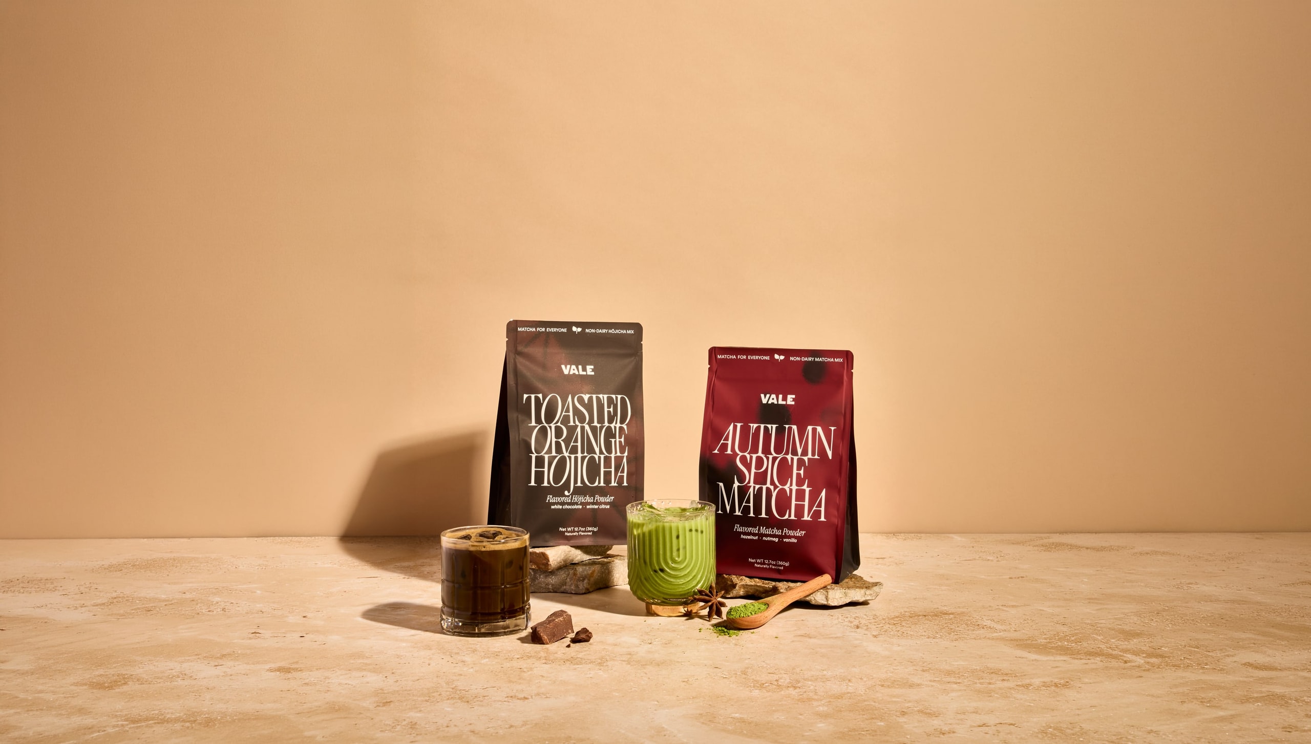 Toasted Orange Hojicha and Autumn Spice Matcha bags with iced pours