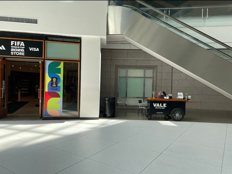 Vale Matcha Bar cart with VALE MATCHA BAR lettering inside Pacific Place in downtown Seattle, near the escalator and stone atrium wall